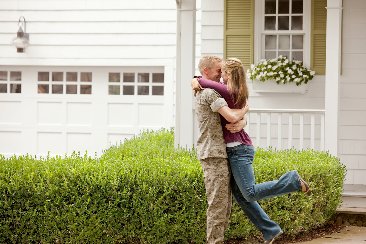 military member and wife hugging