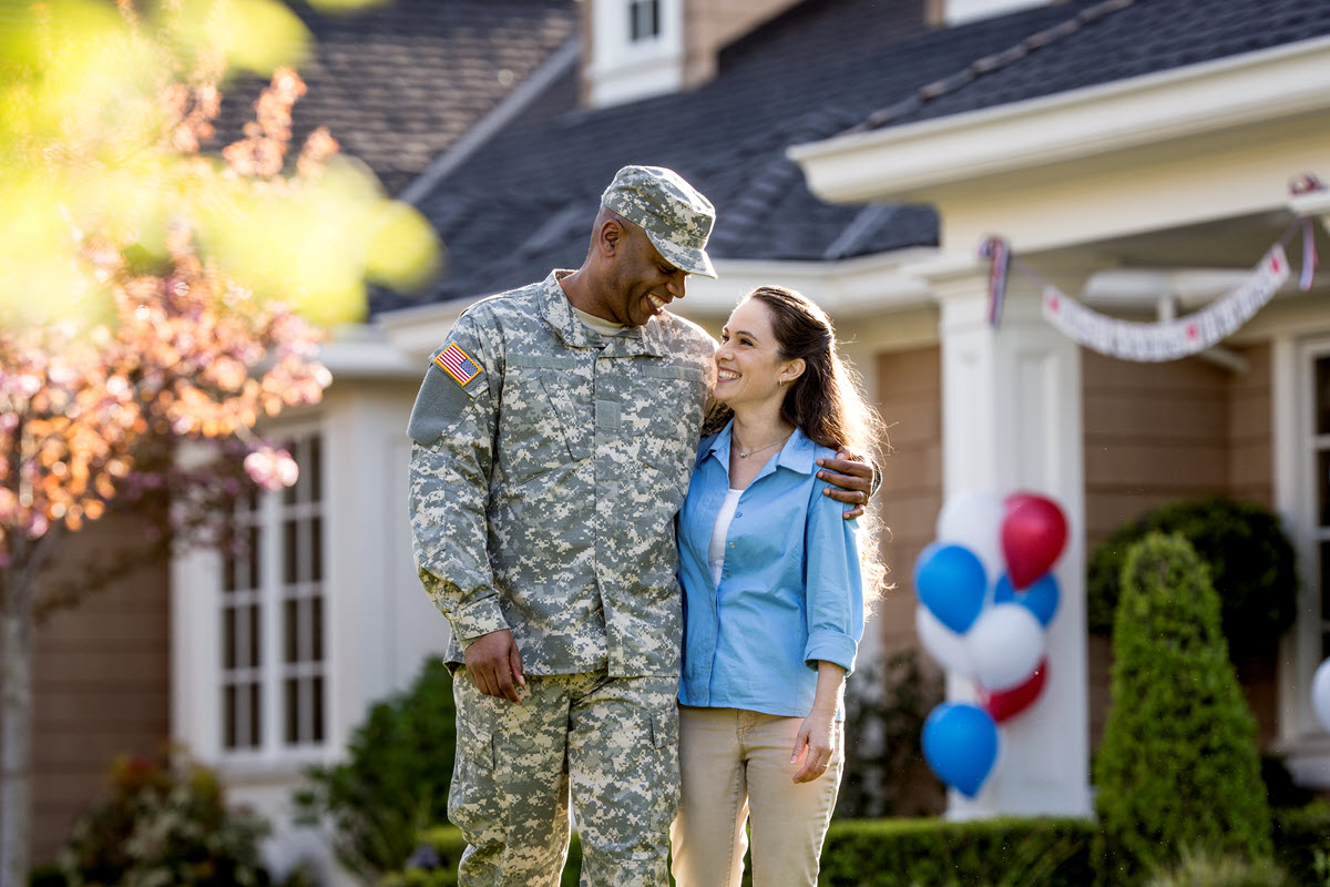 military member and wife smiling