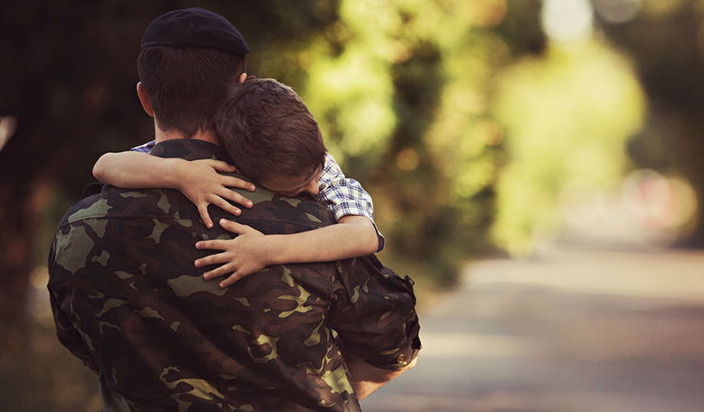 military member holding son