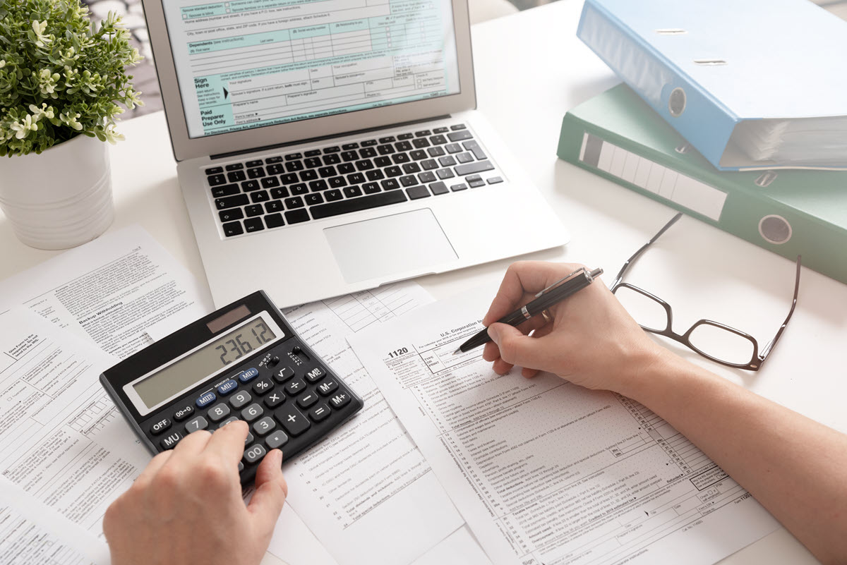 table with tax information and computer and calculator