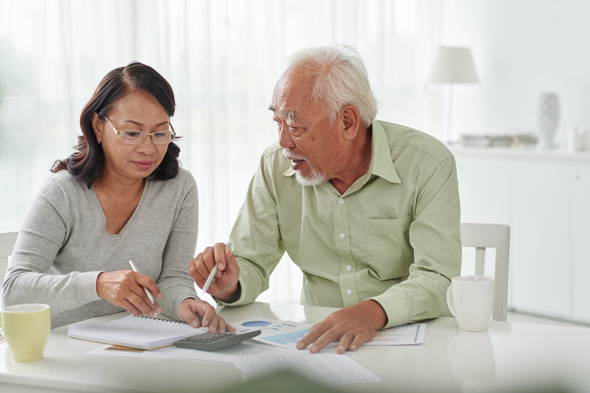 older couple looking at a bill