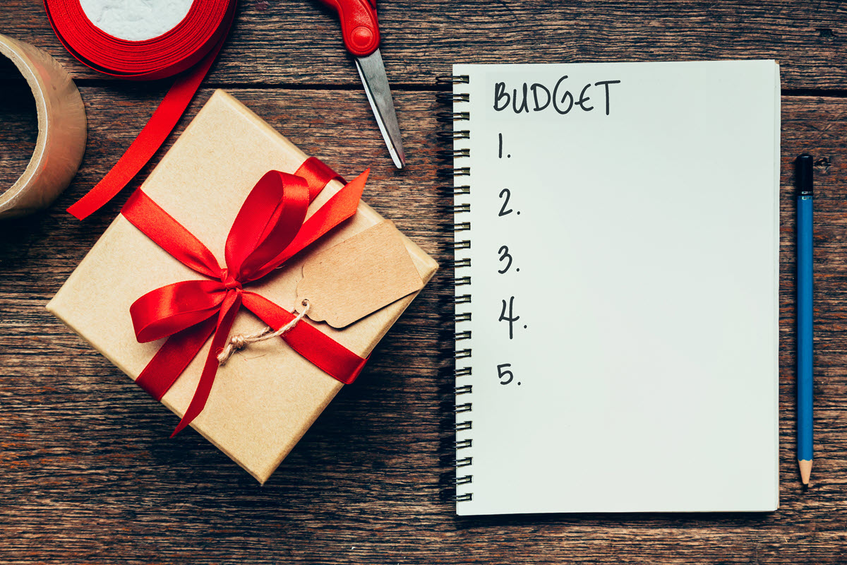 budget checklist with a notebook, present and pencil