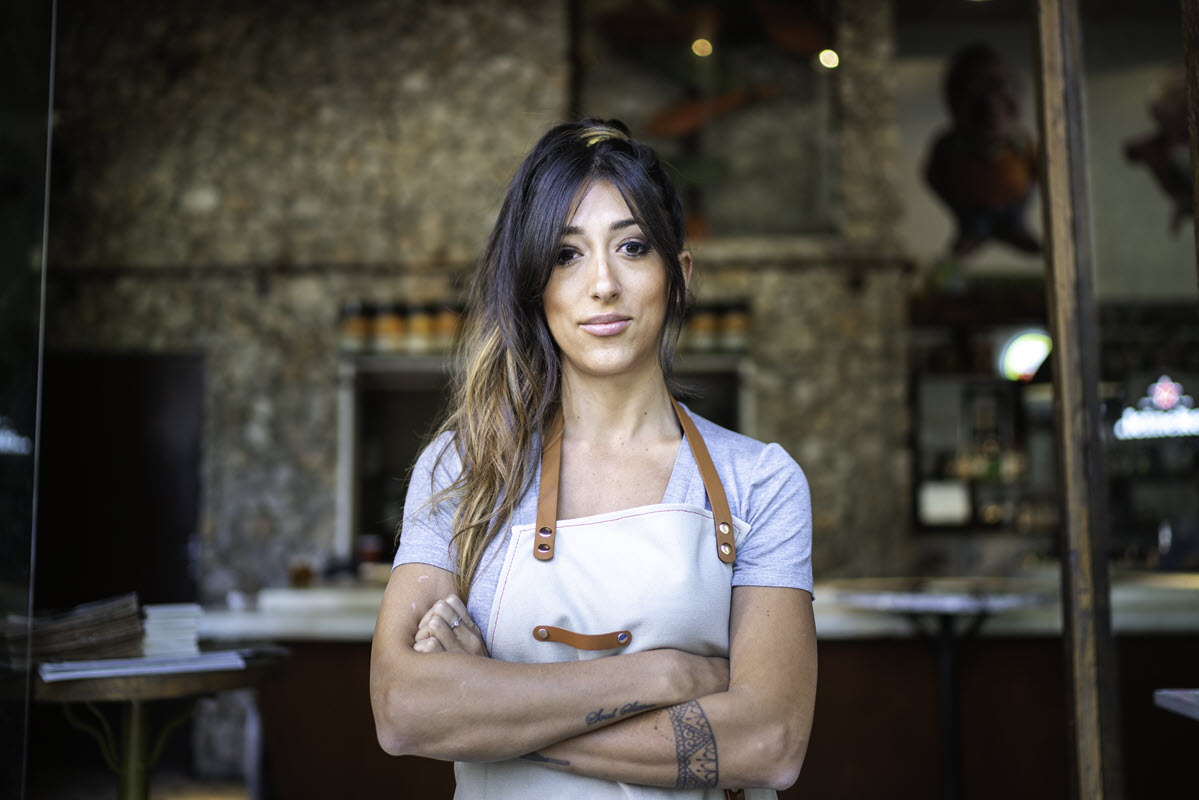 woman business owner folding arms