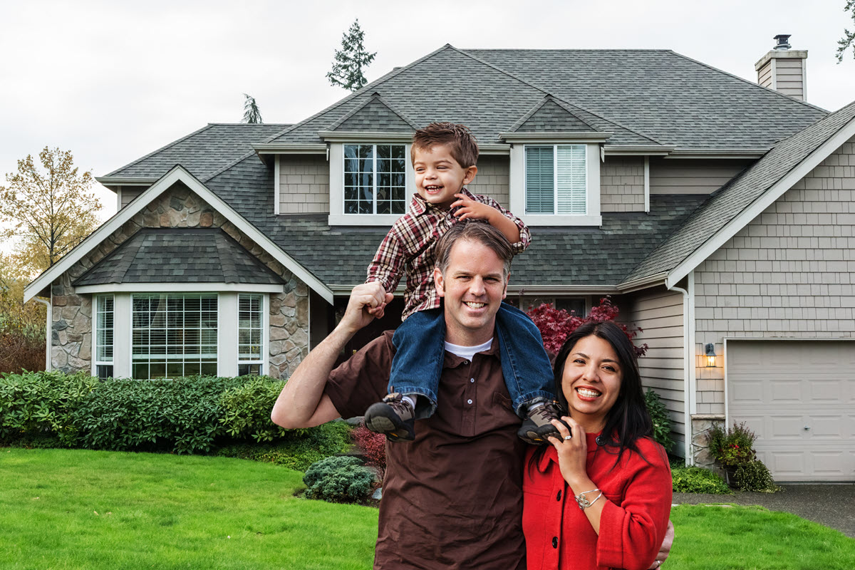 happy family in front of a house