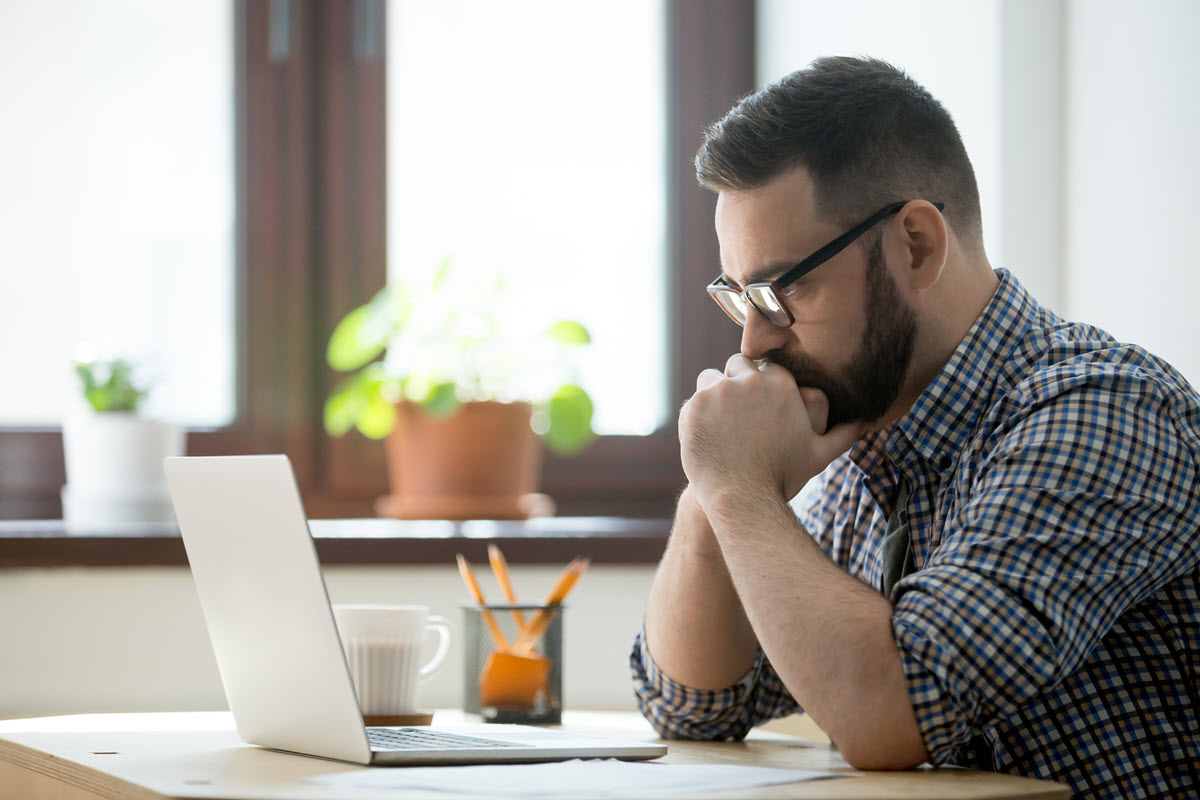 concerned man in front of computer