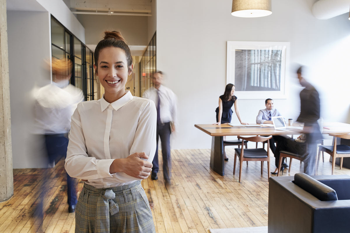 woman standing in an office smiling